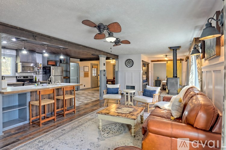 A living room with a brown leather couch and a wooden coffee table.