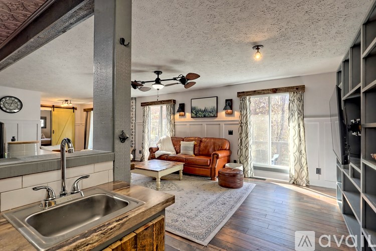 A kitchen with a sink and a ceiling fan.