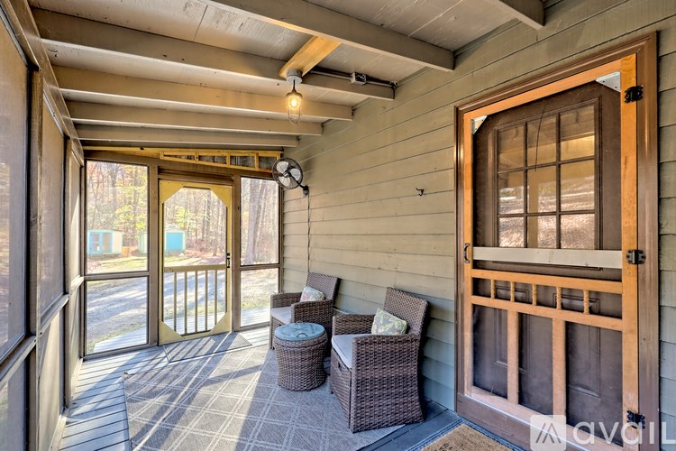 A balcony with a chair and a table.