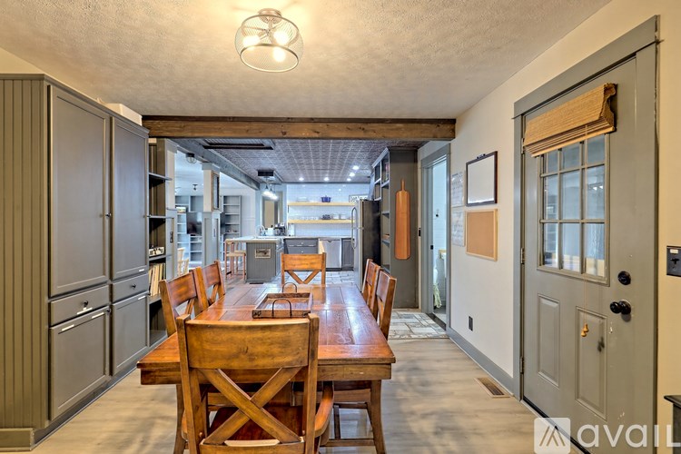A kitchen with a table and chairs in the middle of the room.