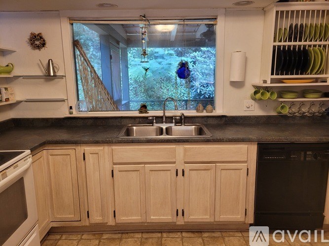 A kitchen with wooden cabinets and a black countertop.