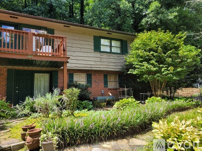 A house with a green door and a balcony.
