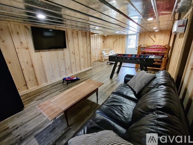 A living room with a couch, table, and television.
