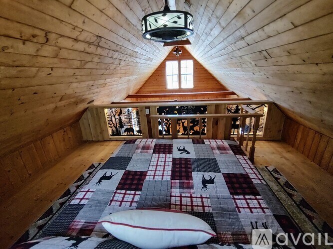 A bedroom with a bed in the middle of the room.