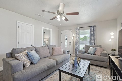A living room with a grey couch and a coffee table.