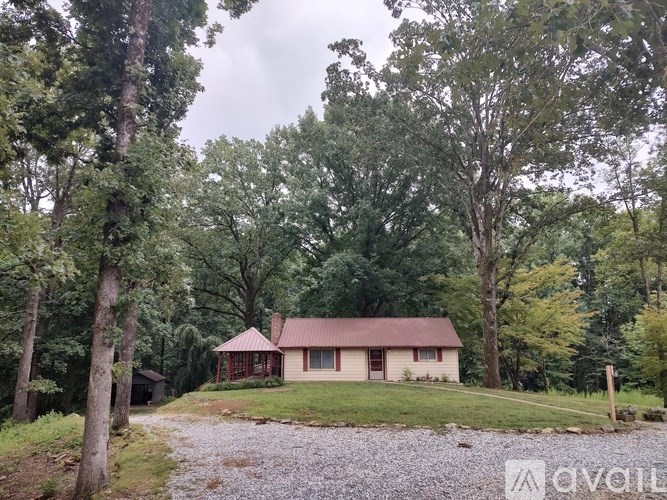 A house is surrounded by trees in a wooded area.