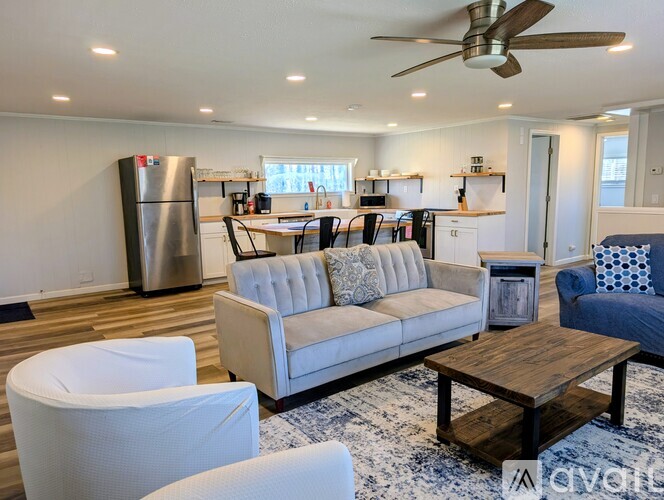A kitchen with a table and chairs in front of it.