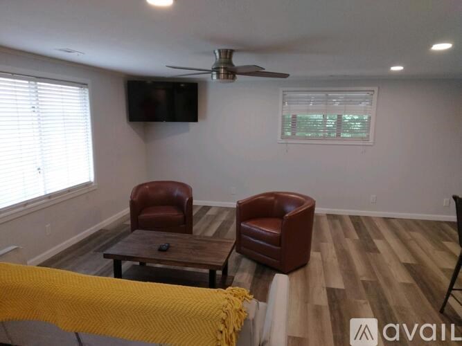 A living room with a brown leather chair and a wooden coffee table.