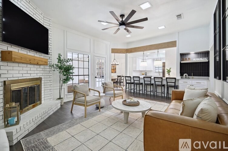 A living room with a fireplace and a television on the wall.