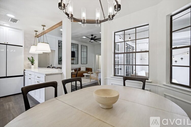 A modern kitchen with a dining table and chairs.