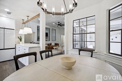 A modern kitchen with a dining table and chairs.