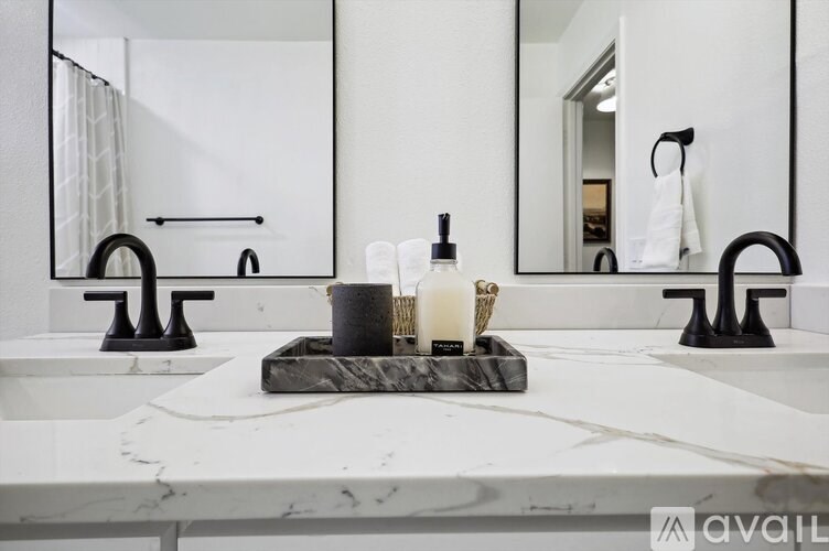 A bathroom with two sinks and a large mirror.