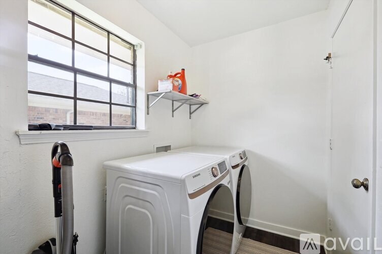 A small laundry room with a washer and dryer.