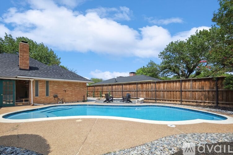 A backyard with a pool and a house.