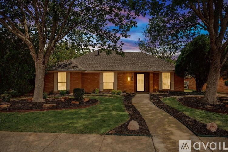 A house with a front yard and a walkway leading to the front door.