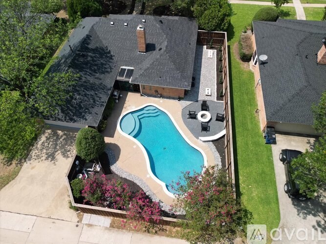 A backyard with a pool and a hot tub.