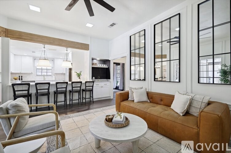 A living room with a brown couch and a white coffee table.