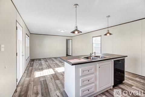 A kitchen with a sink and a counter is available for rent.