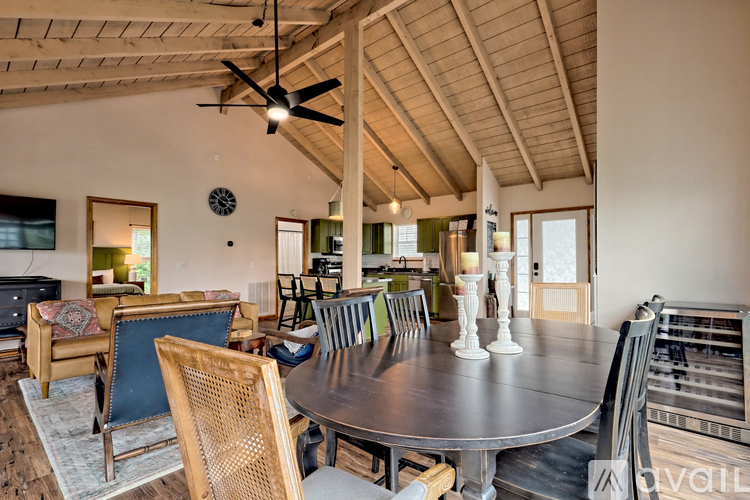 A modern dining room with a round table and chairs.