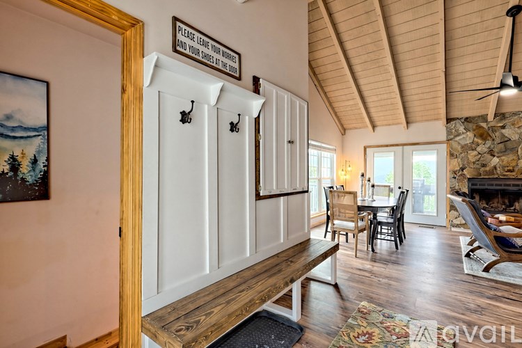 A room with a wooden ceiling and a fireplace.