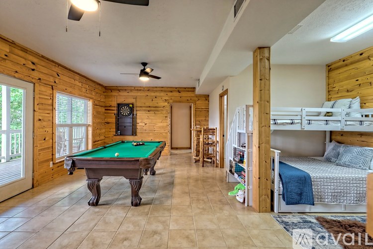 A room with a pool table and bunk beds.