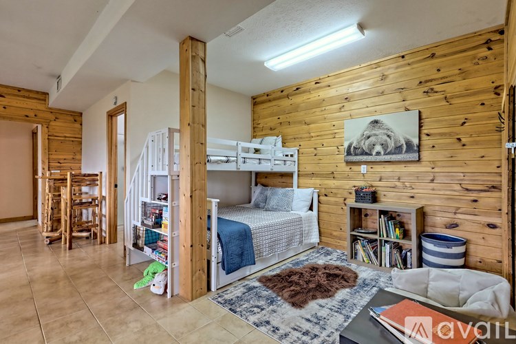 A room with wooden walls and a bed in the center.