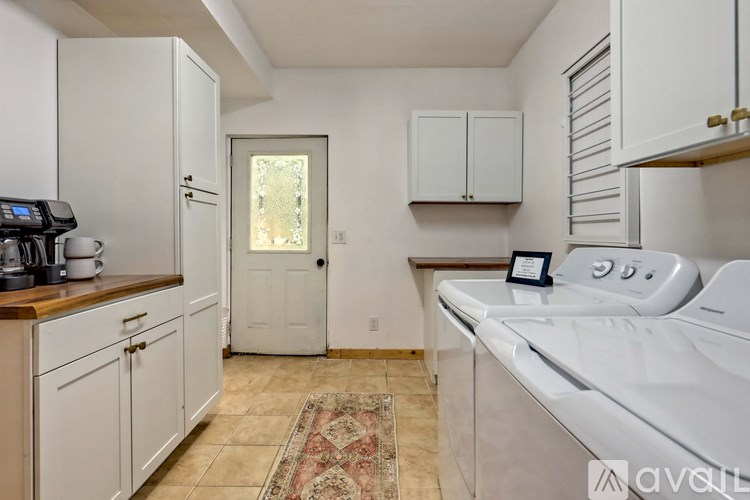 A kitchen with white cabinets and a white oven.