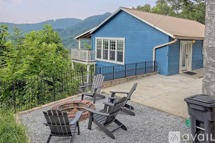 A blue house with a patio and a fire pit.