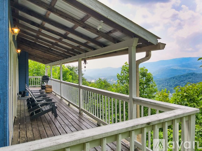 A wooden deck with a view of the mountains.