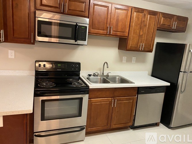 A kitchen with wooden cabinets and stainless steel appliances.