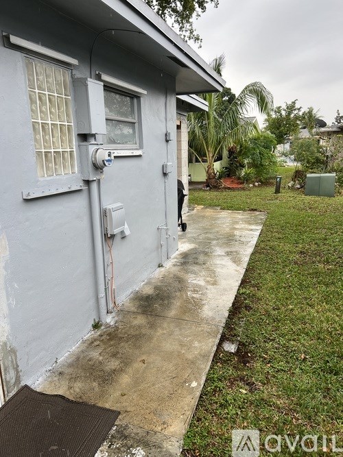 A grey house with a window and a door.
