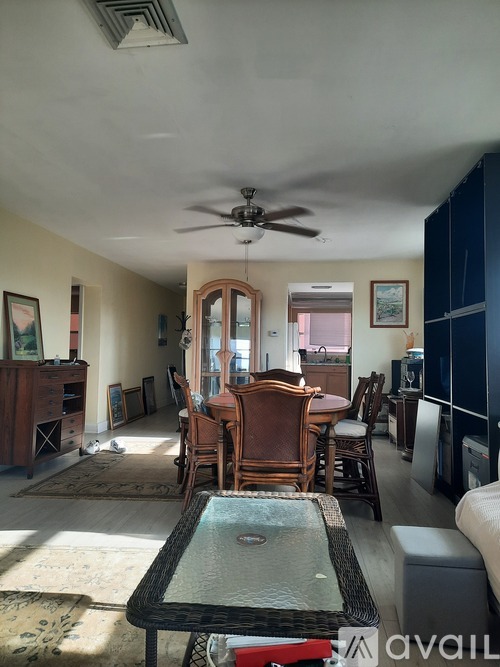 A living room with a dining table and chairs.