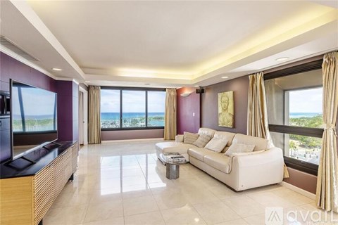 A living room with a white sofa and a coffee table.