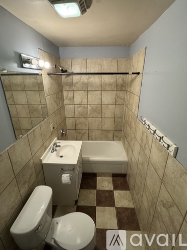 A bathroom with a toilet, sink, and bathtub.