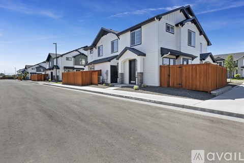 A row of houses with a clear blue sky above them.
