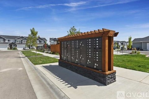 A wooden sign with black numbers stands in front of a row of houses.