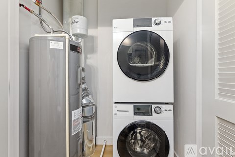 A washing machine and a water heater are installed in a wall.