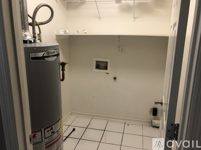 A room with a Snithe tank on the left and a toilet in the middle.