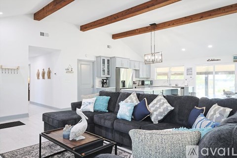 A living room with a grey couch and a coffee table.