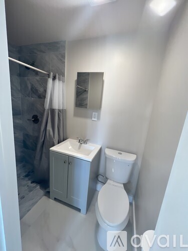 A white toilet and sink in a bathroom.