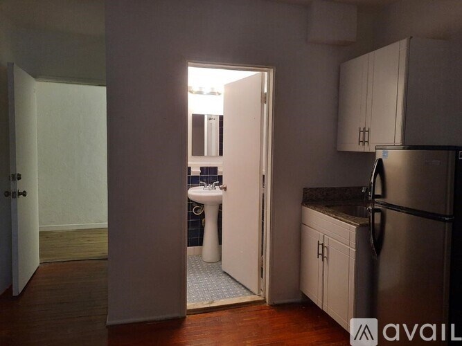 A kitchen with a sink and refrigerator is shown.
