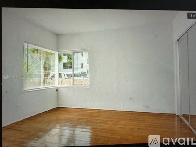 Empty room with wooden floor and white walls.