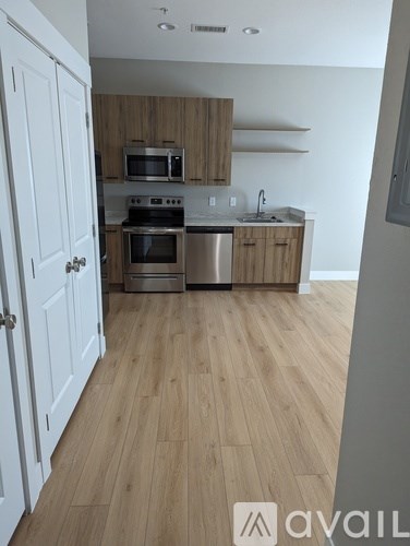 A kitchen with wooden cabinets and a white door.