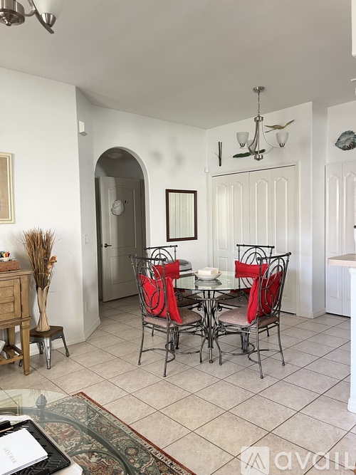 A dining room with a glass table and chairs.