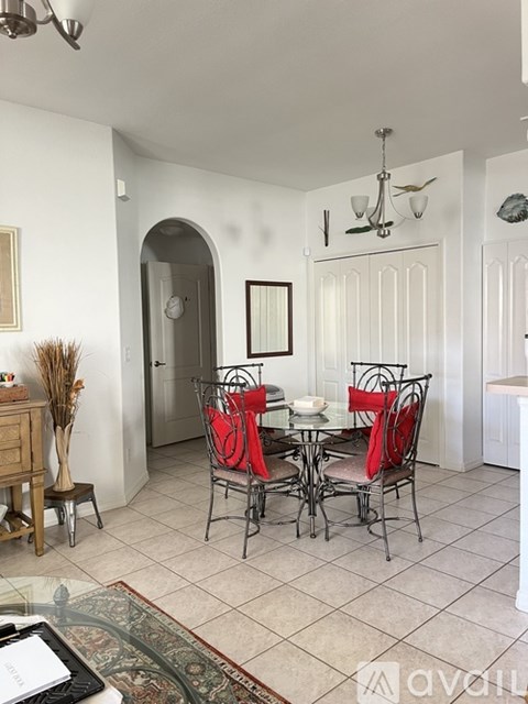A dining room with a glass table and chairs.