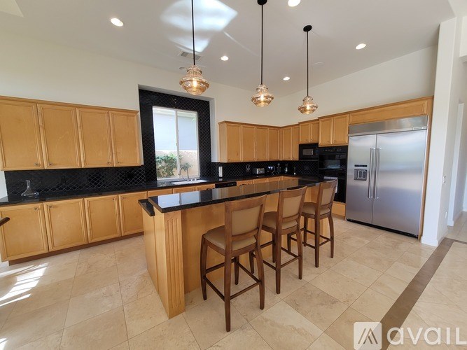 A kitchen with wooden cabinets and a black countertop.