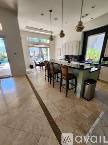 A kitchen with wooden cabinets and a black countertop.