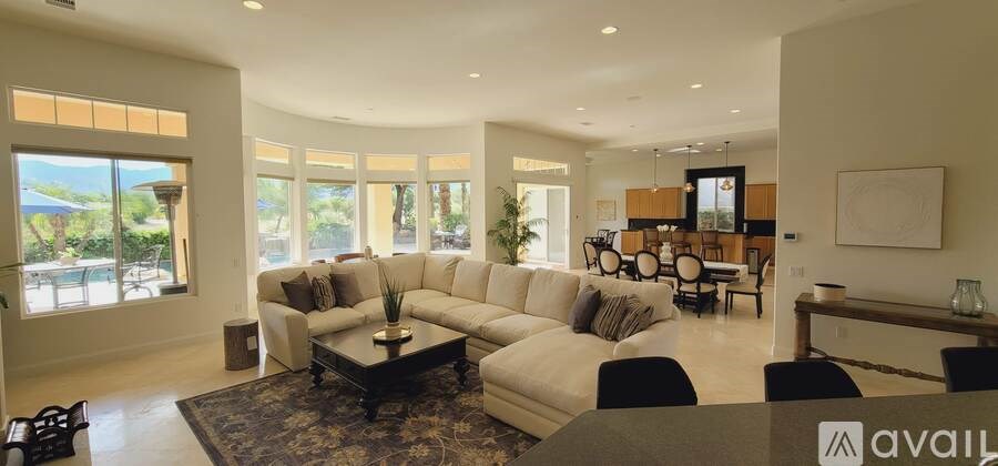 A living room with a large sectional sofa and a coffee table.