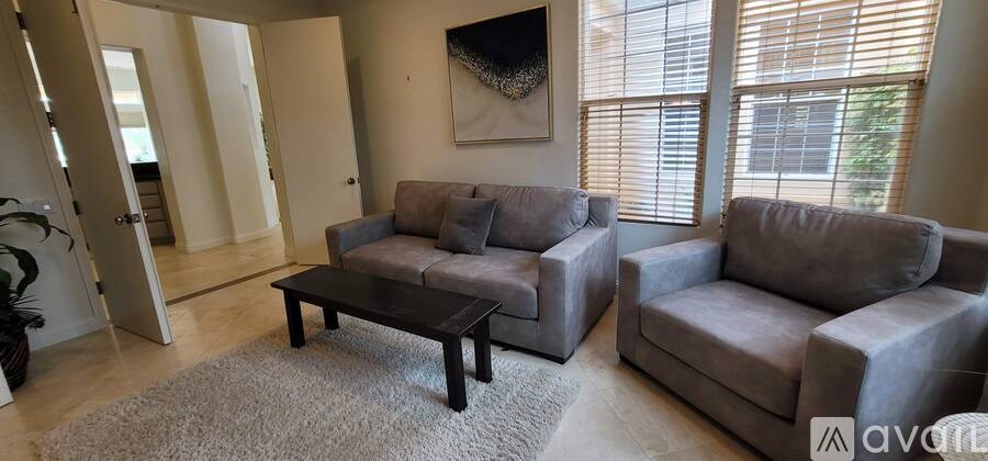 A sunny day at a lake with clear blue water and greenery.