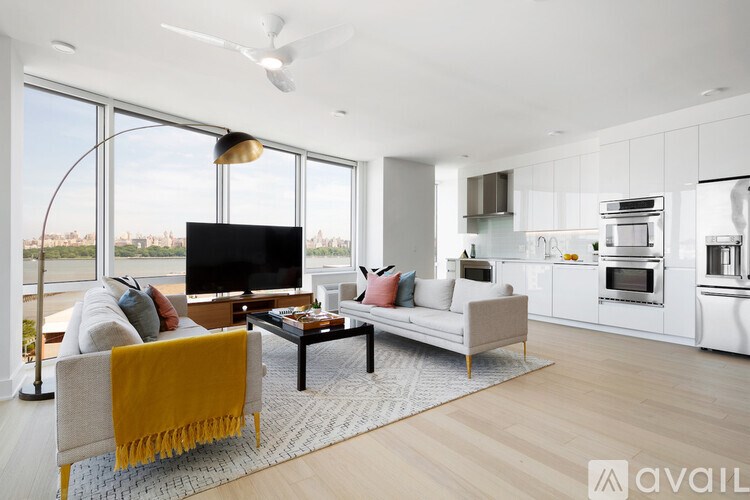 A modern living room with a large window and a flat screen TV.